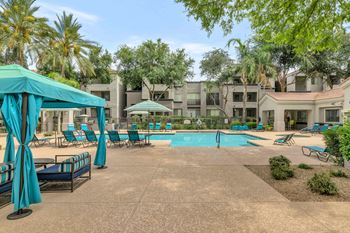 Swimming pool with cabanas and lounge seating area